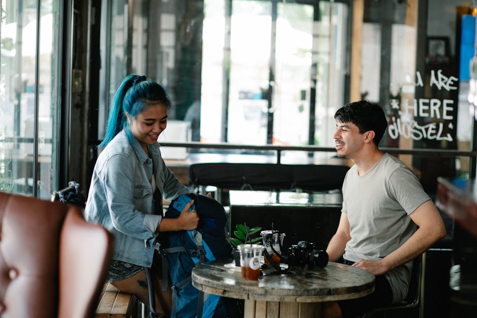 Two friends enjoying beverages and conversation at a cozy café indoors