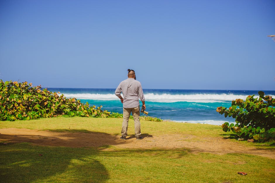 A person enjoys the scenic view of a tropical beach, ideal for a summer vacation