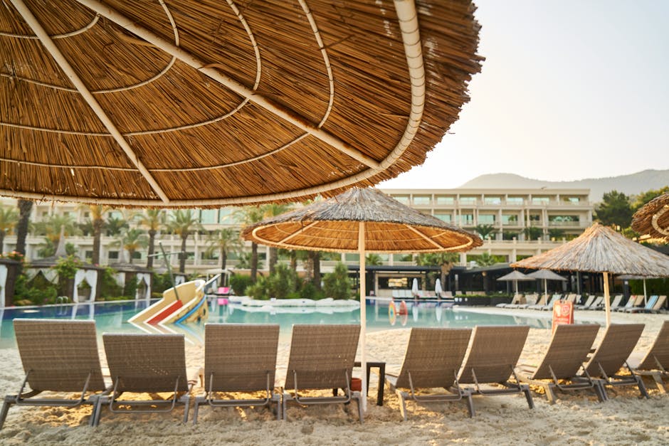 Relaxing poolside at a luxury resort with sunloungers and parasols, perfect for a tranquil summer vacation